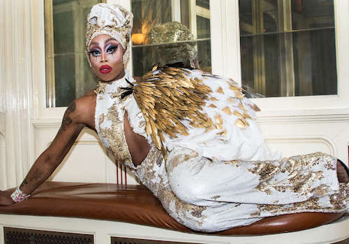 Monique Heart in an angelic white feather outfit.
