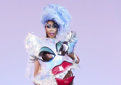 Monique Heart in icy blue outfit with big eyes on it.